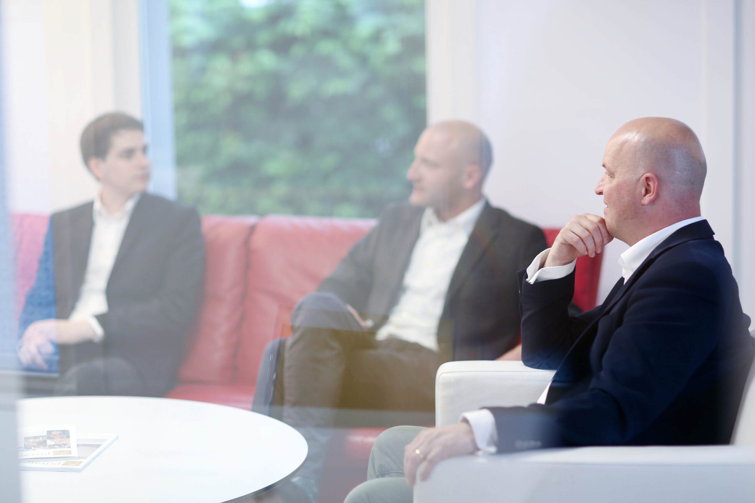 Business advisor and sitting together after securing a successful business sale agreement