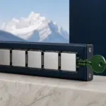 Green authorization key aligned with a sequence of neutral security plates against an Alpine backdrop.